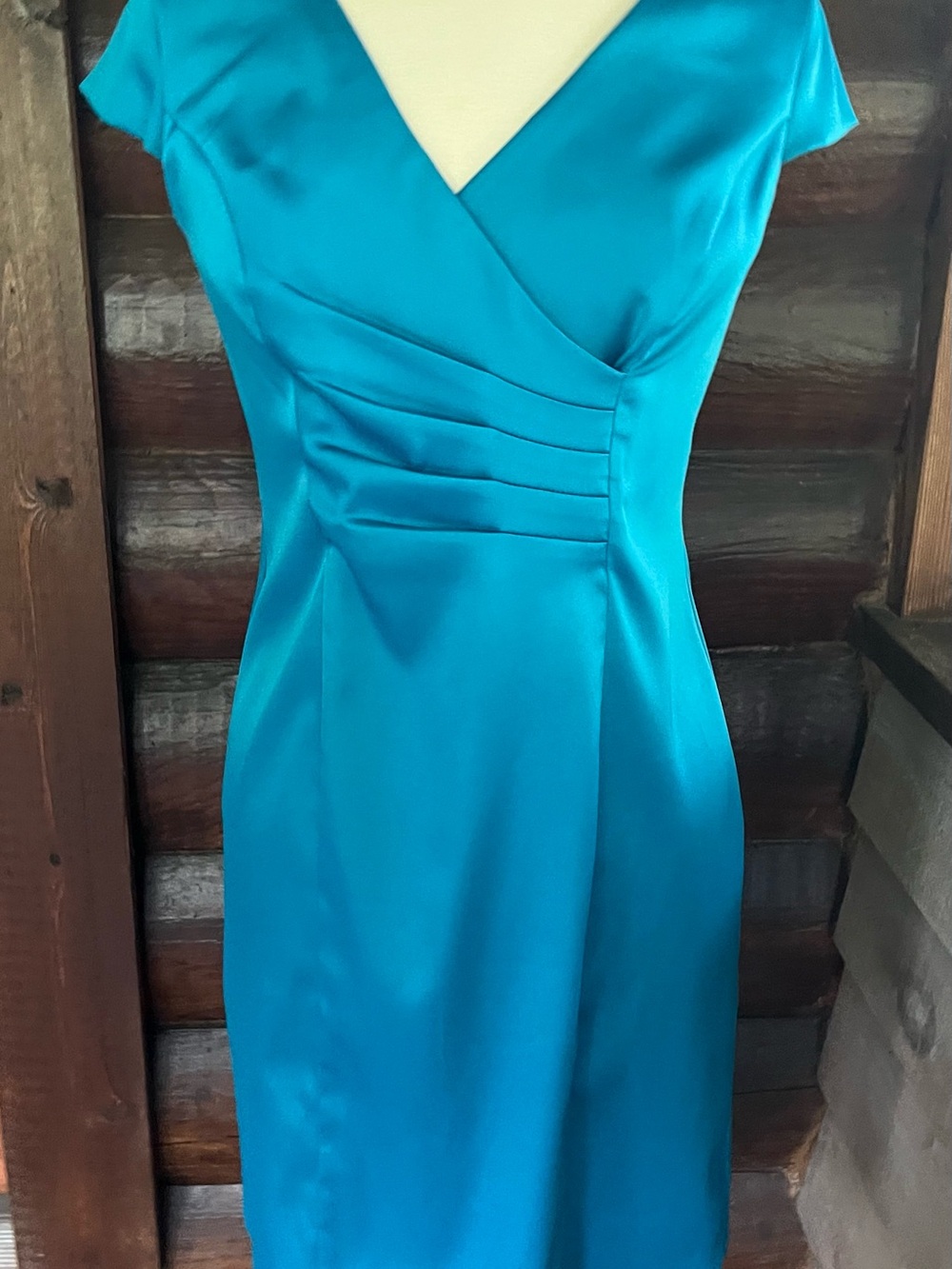 Pretty teal colored dress flattering cut. Stretchy satin.
